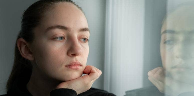 Why I Was Only Attracted To Damaged Men sad woman looking out the window reflection