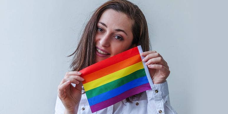 Why Are People With Autism More Likely To Identify As LGBTQ? woman with lgbtq pride flag