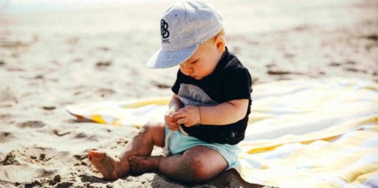 baby playing in the sand