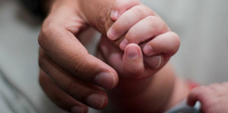 Meet The Blue-Eyed Man Sired 22 Kids (And Counting!) With Donated Sperm adult hand clutching a baby hand