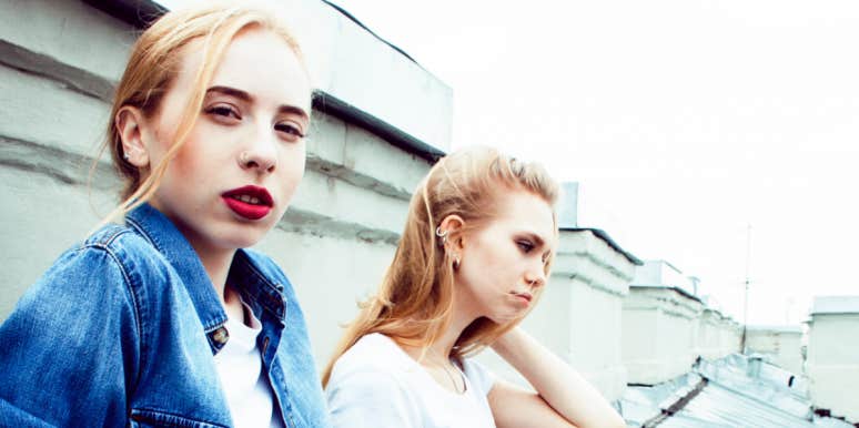 Young blonde women on a rooftop looking moody
