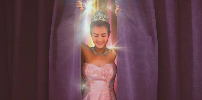 woman at beauty pageant standing between curtains