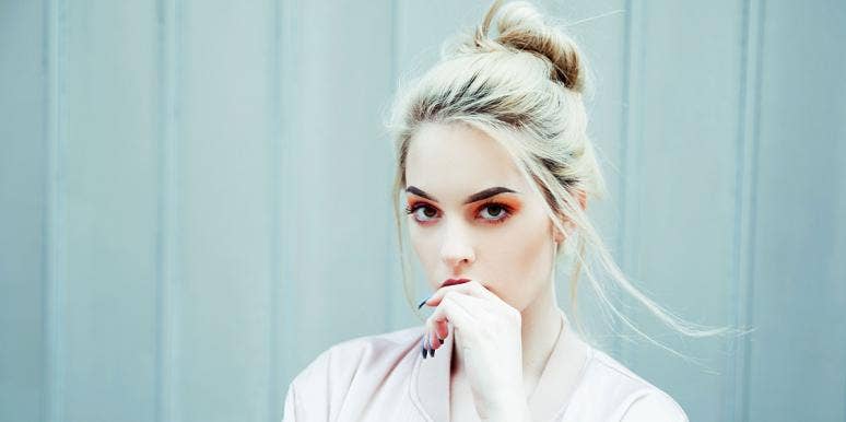 benefits of zinc woman with hand at her lips