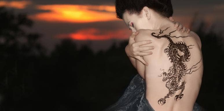woman with dragon tattoo on her back