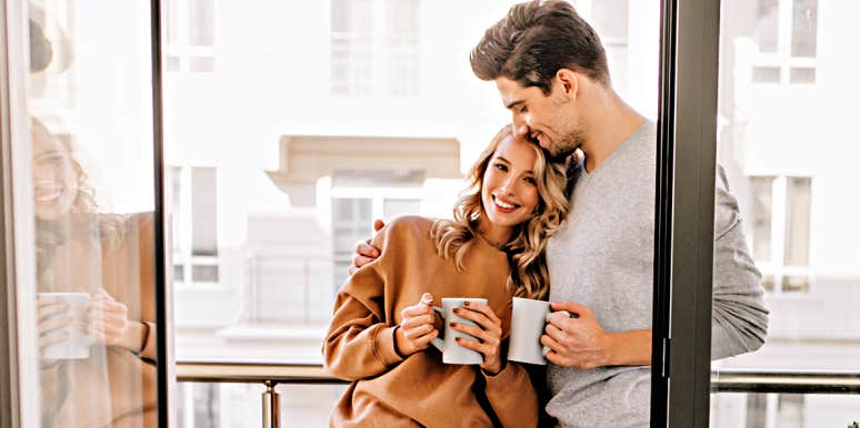 Habits That Make Great Husbands couple being cozy on their balcony