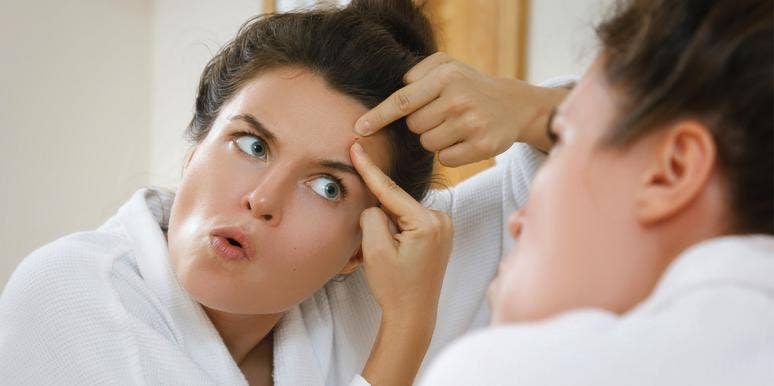 30 Best Pimple Popping Videos To Gross You Out woman popping a pimple in the mirror