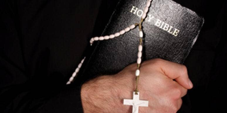 priest holding Bible priest holding Bible