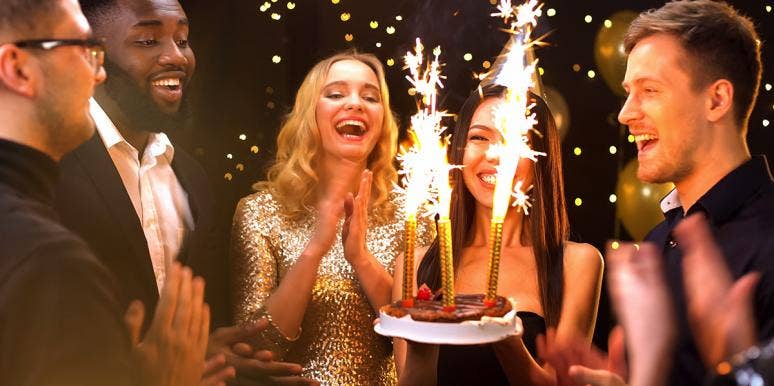 friends celebrating birthday with cake sparklers