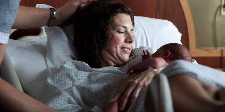 Is This Photo Of A Woman Giving Birth Really Too Vulgar For Facebook? woman holding newborn baby