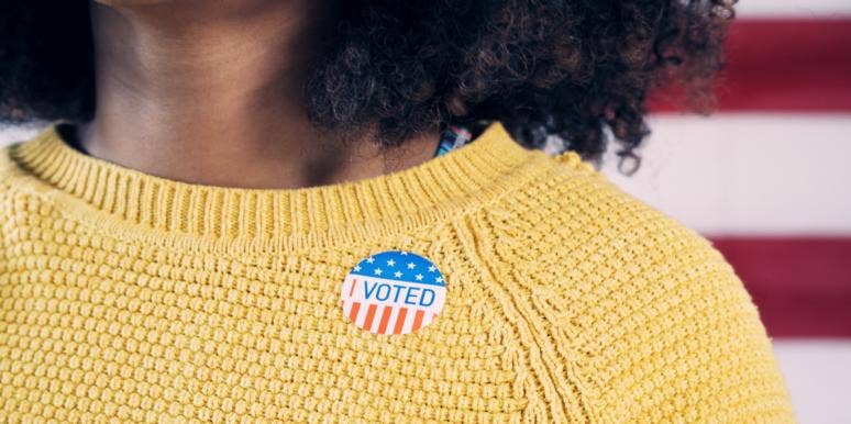 young Black woman wearing an I voted sticker