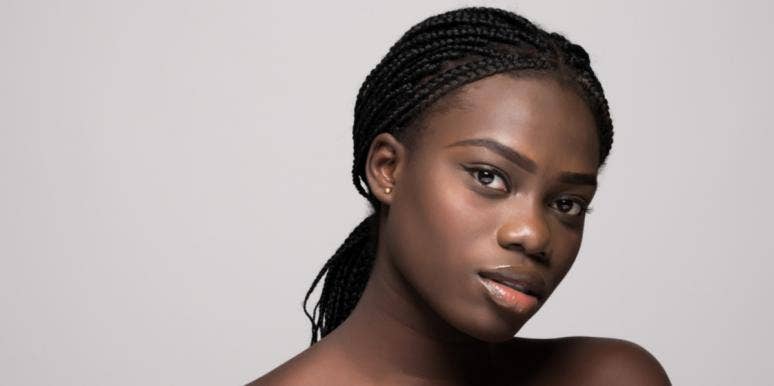 Black Women Can't Always Be Superheroes For Everyone — It's Time We Put Ourselves First young woman staring forward