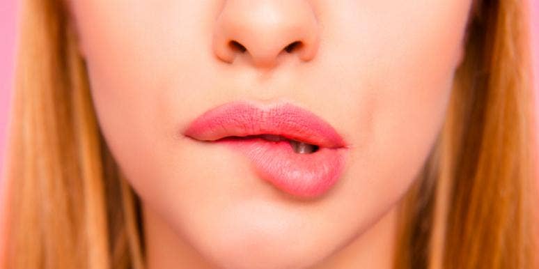 What It Means If Your Body Aches Or You're Sore After Sex woman biting lip
