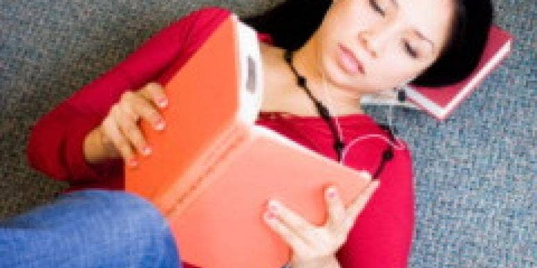woman reading book lying down