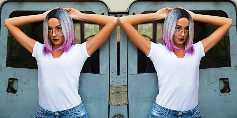 Why We Seek Out Chaotic Relationships — And 3 Realistic Ways To Break The Cycle young woman with colorful hair in front of a train, pondering chaotic relationships