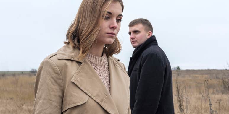 Can't-Miss-'Em Warning Signs That A Breakup Is Imminent man looking at upset woman from a distance