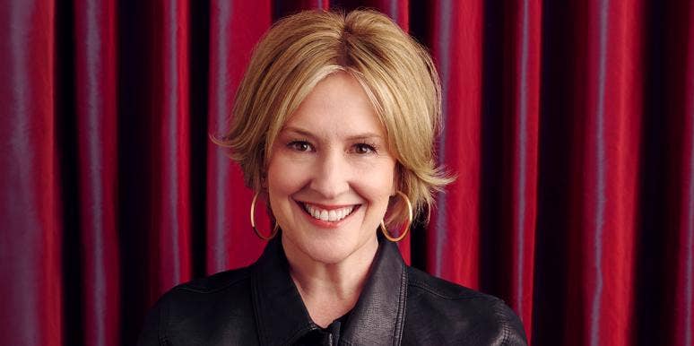 Brené Brown's Facebook Post About 25 Years Of Sobriety Is For Everyone Headshot of Brené Brown looking sassy in front of a red backdrop