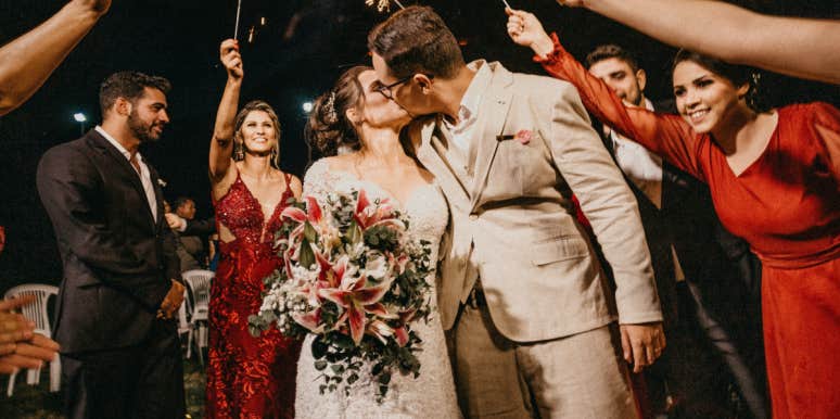 Bride Wants A 'Silent Wedding' & Asks Guests To Whisper During Reception — Her Fiance Says She's 'Irrational' Bride and groom kissing at wedding reception