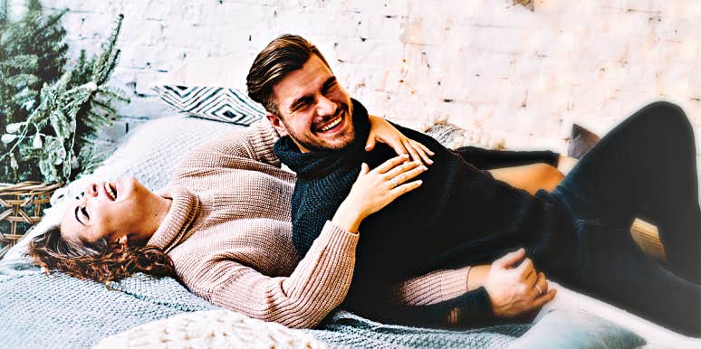 bring joy back to marriage man and woman laughing in bed, wearing sweaters