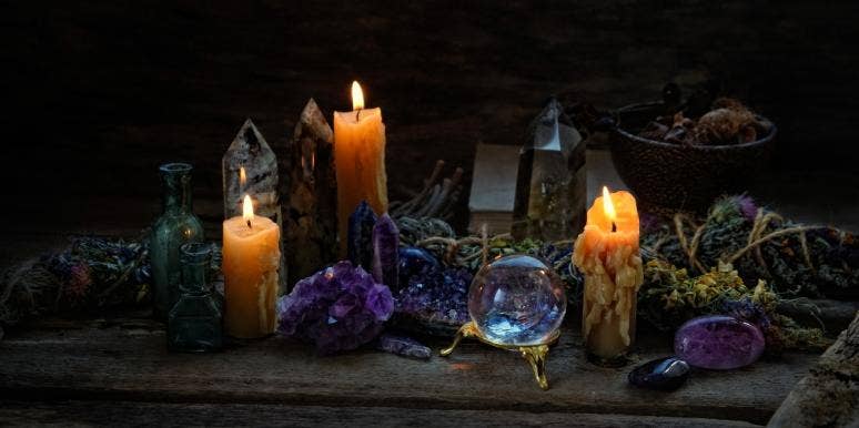 What Is A Bruja Or Brujo in Witchcraft? Brujeria Meaning Explained candles and floral bundles for magic