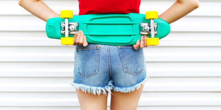 4 Butt Shapes & What Yours Says About Your Health woman in jean shorts holding skateboard behind back