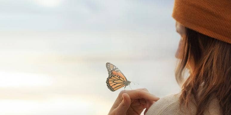 Butterfly Symbolism & Spiritual Meanings Of Seeing Butterflies woman with butterfly on hand