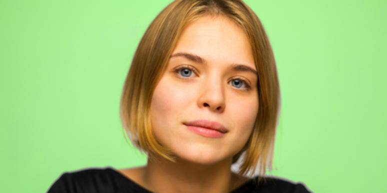 In Relationships, You Can Be Right Or You Can Be Happy woman staring green background