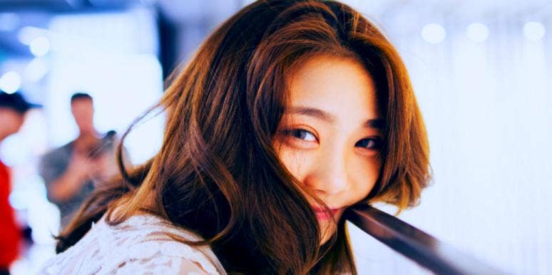 15 Best & Worst Capricorn Traits woman smiling looking forward hidden by hair