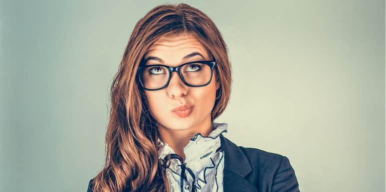 woman in glasses making frustrated face