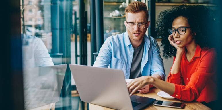 change in the workplace office man and woman looking at laptop