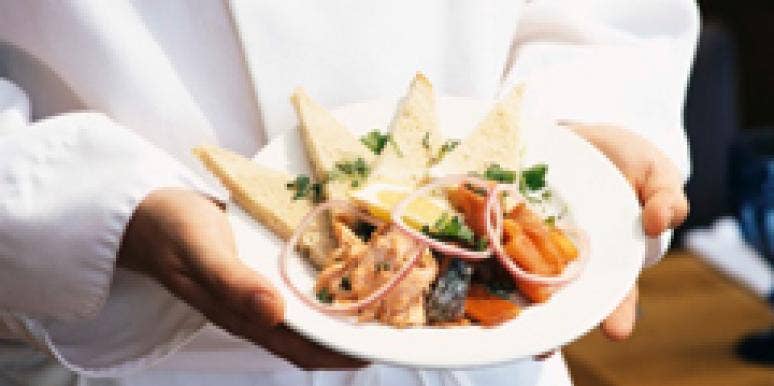 19 Pastimes That Boost A Guy's Sex Appeal chef holding a salmon dish