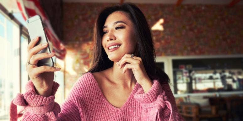 The 12 Chinese Zodiac Signs' Personality Traits - Find Your Animal Sign woman looking at cell phone
