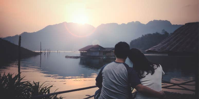 couple watching sunset over lake