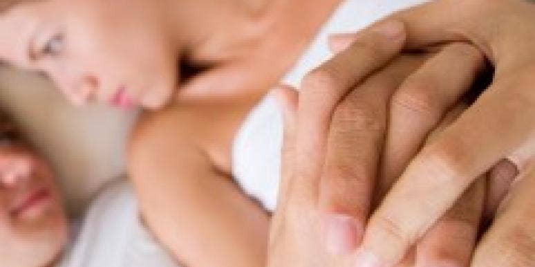 Expert: 5 Key Ingredients For Lasting Love couple in bed with hands clasped