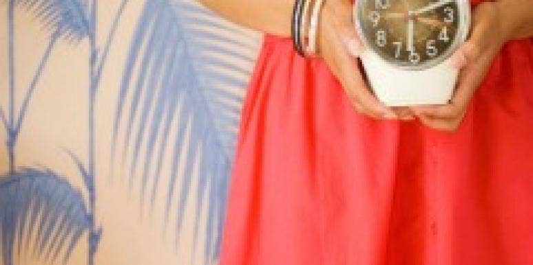 woman holding clock
