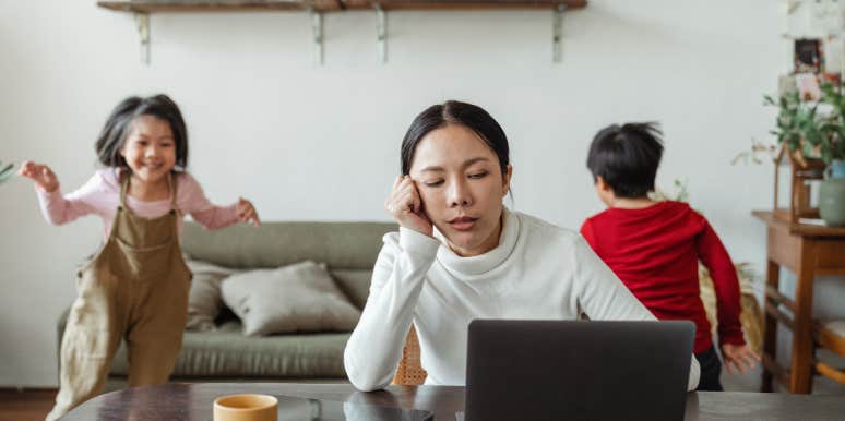 Dad Refuses To Pay Daughter For Babysitting Her Younger Siblings Because She Lives In His House 'Rent Free' woman working on computer with young kids