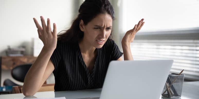 upset woman looking a job offer on computer