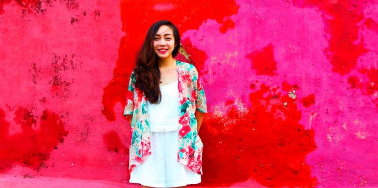 12 Cardinal Habits Of A Strong, Confident Woman confident woman standing against pink background