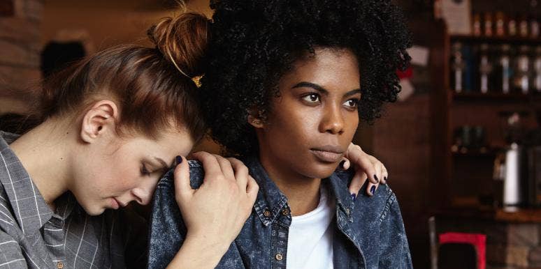 Black woman with white woman leaning on her shoulder Black woman with white woman leaning on her shoulder
