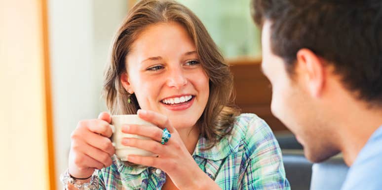 Woman speaks with man over coffee