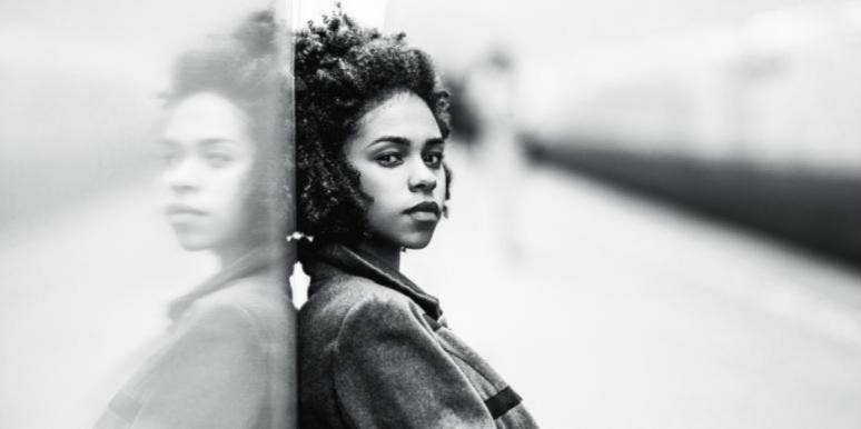 coping with anxiety in 3 helpful steps A young woman with chin-length natural curly hair leaning against a wall, looking into the camera