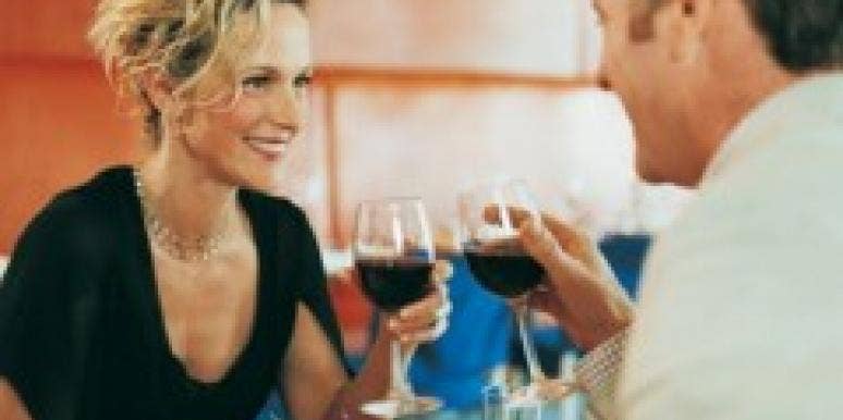 couple at dinner sipping wine