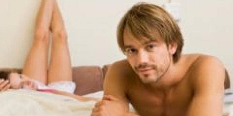 Do You Know What Men Want In Bed? white couple relaxing in bed man in forefront woman legs raised