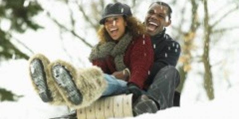 couple sledding in snow