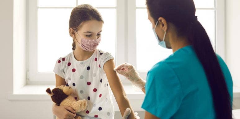covid vaccine for kids little girl getting a vaccine from a nurse
