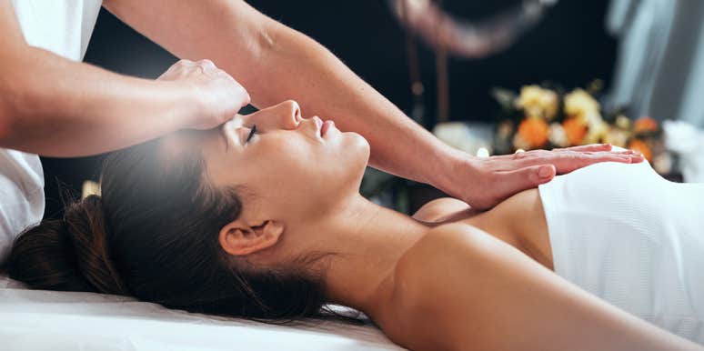 What The Crown Chakra Represents & How To Unblock Yours woman getting her crown chakra healed