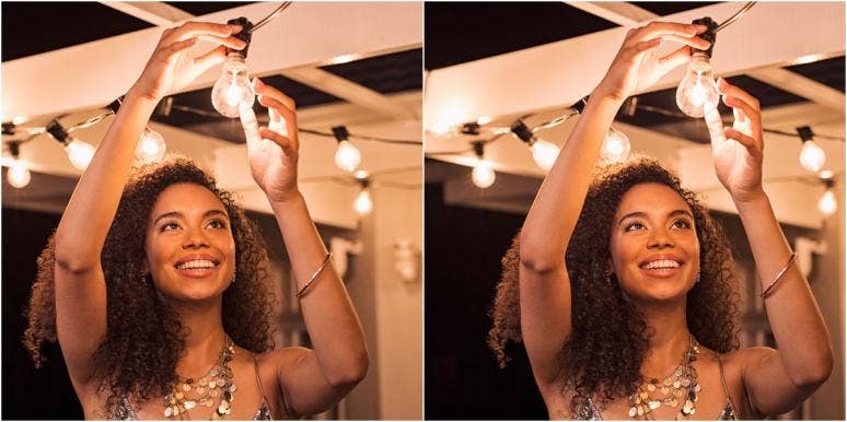 crown chakra happy woman fixing a lightbulb