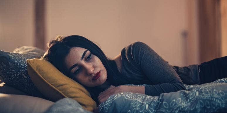 woman sad in bed