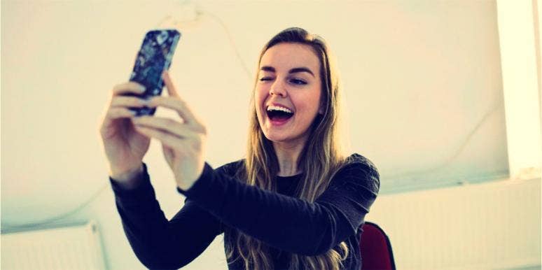 Woman taking selfie for dating profile pictures