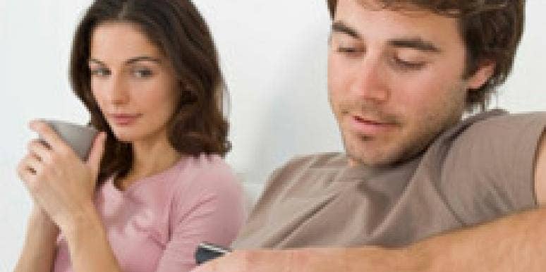 man texting on phone ignoring woman