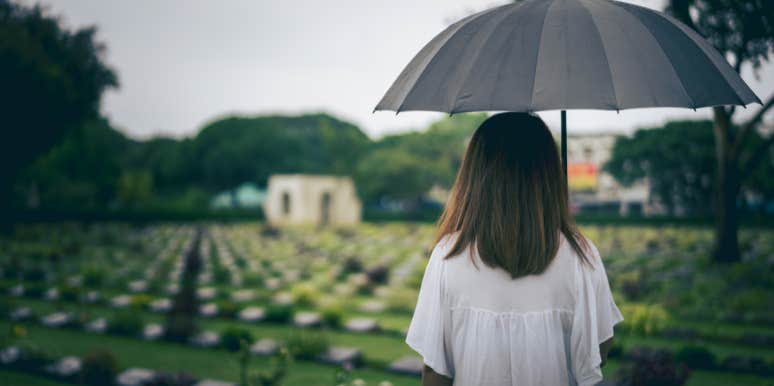 woman in a graveyard with an umbrella